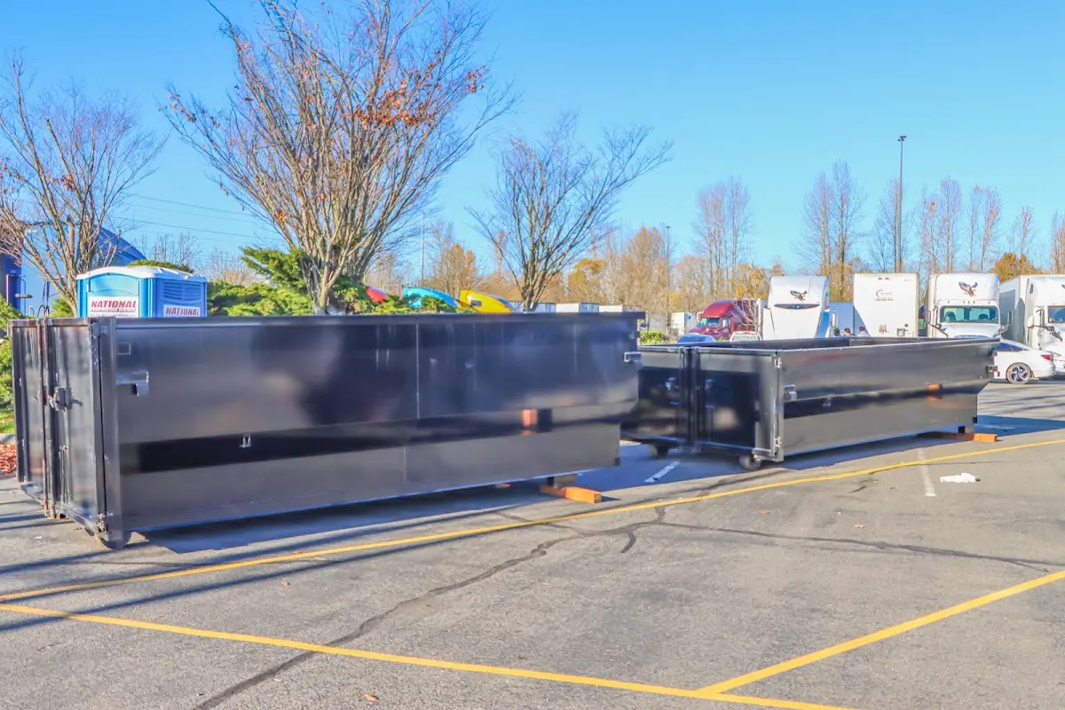 Professional dumpster rental service with roll-off container on residential driveway in Eagle Point
